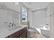 Bright bathroom features a vanity with a large mirror, a shower-tub combo, and neutral walls at 25 Firefly Ln, Youngsville, NC 27596
