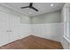 Well lit bedroom with neutral paint and classic white wainscotting wall trim at 25 Firefly Ln, Youngsville, NC 27596