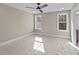 Cozy bedroom with carpet and neutral walls, filled with natural light from two windows at 25 Firefly Ln, Youngsville, NC 27596