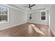 Spacious bedroom with hardwood floors, three large windows, and neutral paint at 25 Firefly Ln, Youngsville, NC 27596