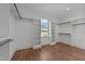 Walk-in closet with hardwood floors, window, and lots of shelving space at 25 Firefly Ln, Youngsville, NC 27596