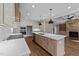 Open kitchen featuring a large island, stainless steel appliances, and hardwood floors at 25 Firefly Ln, Youngsville, NC 27596