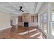 Bright living room with stone fireplace, built-in shelving, coffered ceiling and access to the outdoor living space at 25 Firefly Ln, Youngsville, NC 27596