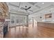Open-concept living room with stone fireplace, access to the deck, and views into the kitchen at 25 Firefly Ln, Youngsville, NC 27596