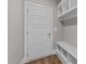 Mudroom featuring a white door, white shelves, and a small bench for added convenience and storage at 25 Firefly Ln, Youngsville, NC 27596