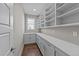 Spacious walk-in pantry with white cabinets, counters, and shelves at 25 Firefly Ln, Youngsville, NC 27596