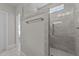 Glass enclosed shower with gray tiling and a built in shower seat at 25 Firefly Ln, Youngsville, NC 27596
