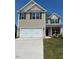 Charming two-story home with a two car garage, manicured lawn, and neutral colored siding at 238 Plains Dr # 313, Burlington, NC 27217