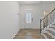 Bright entryway with hardwood floors, staircase, and coat rack at 321 Masden Rd, Holly Springs, NC 27540