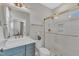 Modern bathroom with green vanity, walk-in shower, and gold fixtures at 616 Silver Comet Dr, Knightdale, NC 27545