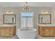 Elegant bathroom with double sinks, freestanding tub, and gold fixtures at 616 Silver Comet Dr, Knightdale, NC 27545