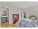 Bedroom with striped bedding, dresser, and en-suite bathroom at 616 Silver Comet Dr, Knightdale, NC 27545