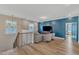 Spacious bonus room with blue accent wall, comfy seating, and a large TV at 616 Silver Comet Dr, Knightdale, NC 27545