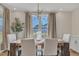 Bright dining room with wood table, white chairs, and large windows at 616 Silver Comet Dr, Knightdale, NC 27545