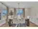 Bright dining room with wood table, white chairs, and large windows at 616 Silver Comet Dr, Knightdale, NC 27545