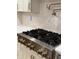 Close-up of a stainless steel gas cooktop with gold knobs at 616 Silver Comet Dr, Knightdale, NC 27545
