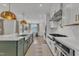 Modern kitchen with white cabinets, gas cooktop, and dining area at 616 Silver Comet Dr, Knightdale, NC 27545