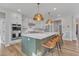 Modern kitchen with green island, white cabinets, and gold accents at 616 Silver Comet Dr, Knightdale, NC 27545