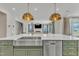 Modern kitchen island with sink, dishwasher, and gold fixtures at 616 Silver Comet Dr, Knightdale, NC 27545