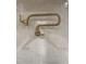 Modern gold kitchen faucet with gooseneck design against white tile backsplash at 616 Silver Comet Dr, Knightdale, NC 27545