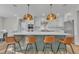 Modern kitchen with green island, gold light fixtures, and stainless steel appliances at 616 Silver Comet Dr, Knightdale, NC 27545