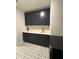 Laundry room with dark cabinets, quartz countertops, and patterned tile at 616 Silver Comet Dr, Knightdale, NC 27545