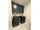Laundry room with washer, dryer, and dark cabinets at 616 Silver Comet Dr, Knightdale, NC 27545