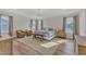 Main bedroom with king-size bed, two armchairs, and hardwood floors at 616 Silver Comet Dr, Knightdale, NC 27545