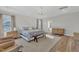 Main bedroom with king-size bed, two armchairs, and hardwood floors at 616 Silver Comet Dr, Knightdale, NC 27545