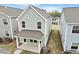 Exterior shot of a home's backyard and patio with green vinyl siding and dark roof at 707 Georgias Landing Pkwy # 105, Raleigh, NC 27603