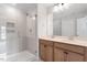 This bright bathroom has a tiled shower, a double vanity, and neutral colored walls at 707 Georgias Landing Pkwy # 105, Raleigh, NC 27603