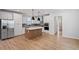 Modern kitchen featuring white cabinets, an island, and stainless steel appliances at 707 Georgias Landing Pkwy # 105, Raleigh, NC 27603