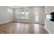 Spacious living room featuring recessed lighting, large windows, and a glass door leading to the backyard at 707 Georgias Landing Pkwy # 105, Raleigh, NC 27603