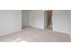 The main bedroom has neutral colored walls and carpet, a walk-in closet, and an en suite bathroom at 707 Georgias Landing Pkwy # 105, Raleigh, NC 27603