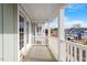 View of a porch with white railings overlooking a neighborhood with construction in progress at 707 Georgias Landing Pkwy # 105, Raleigh, NC 27603