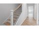 Modern staircase with wooden steps and black metal railings at 707 Georgias Landing Pkwy # 105, Raleigh, NC 27603