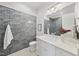 Bathroom with gray tile, marble vanity, and modern fixtures at 909 N Gregson St, Durham, NC 27701