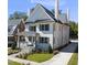 Elegant two-story home featuring a manicured lawn and a newly paved driveway, blending classic charm at 909 N Gregson St, Durham, NC 27701