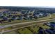 Aerial view of a neighborhood with houses, roads, and a large green area at 102 Dungannon Loop, Clayton, NC 27520