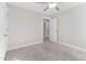 Well-lit bedroom with carpet, door to hallway, and neutral walls at 102 Dungannon Loop, Clayton, NC 27520