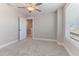 Bedroom with window, ceiling fan, and access to hallway at 102 Dungannon Loop, Clayton, NC 27520