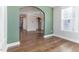 Bright breakfast nook with hardwood floors and green accent wall at 102 Dungannon Loop, Clayton, NC 27520