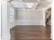 Formal dining room with hardwood floors, wainscoting, and coffered ceiling at 102 Dungannon Loop, Clayton, NC 27520