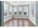 Bright sunroom with hardwood floors and multiple windows at 102 Dungannon Loop, Clayton, NC 27520