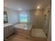Bright bathroom boasting a soaking tub, a separate tiled shower, and modern fixtures at 111 Demascus Way # 021, Four Oaks, NC 27524