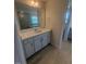 Bathroom featuring a granite countertop, gray cabinets, and a well-lit vanity mirror at 111 Demascus Way # 021, Four Oaks, NC 27524