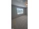 Bedroom with plush carpeting, neutral walls, and a window with backyard views at 111 Demascus Way # 021, Four Oaks, NC 27524