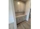 Butler's pantry featuring gray cabinets with granite countertops and light hardwood floors at 111 Demascus Way # 021, Four Oaks, NC 27524
