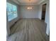 Bright dining room featuring wainscoting, light hardwood floors, and a modern chandelier at 111 Demascus Way # 021, Four Oaks, NC 27524