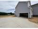 Gray home with a concrete driveway leading to an attached garage at 111 Demascus Way # 021, Four Oaks, NC 27524
